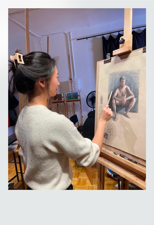 Sabrina painting at an easel